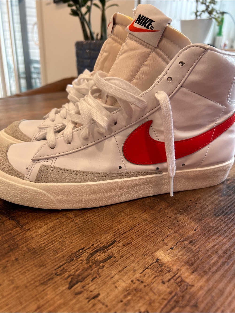 Nike Women’s White High-Top Sneakers with Red Swoosh